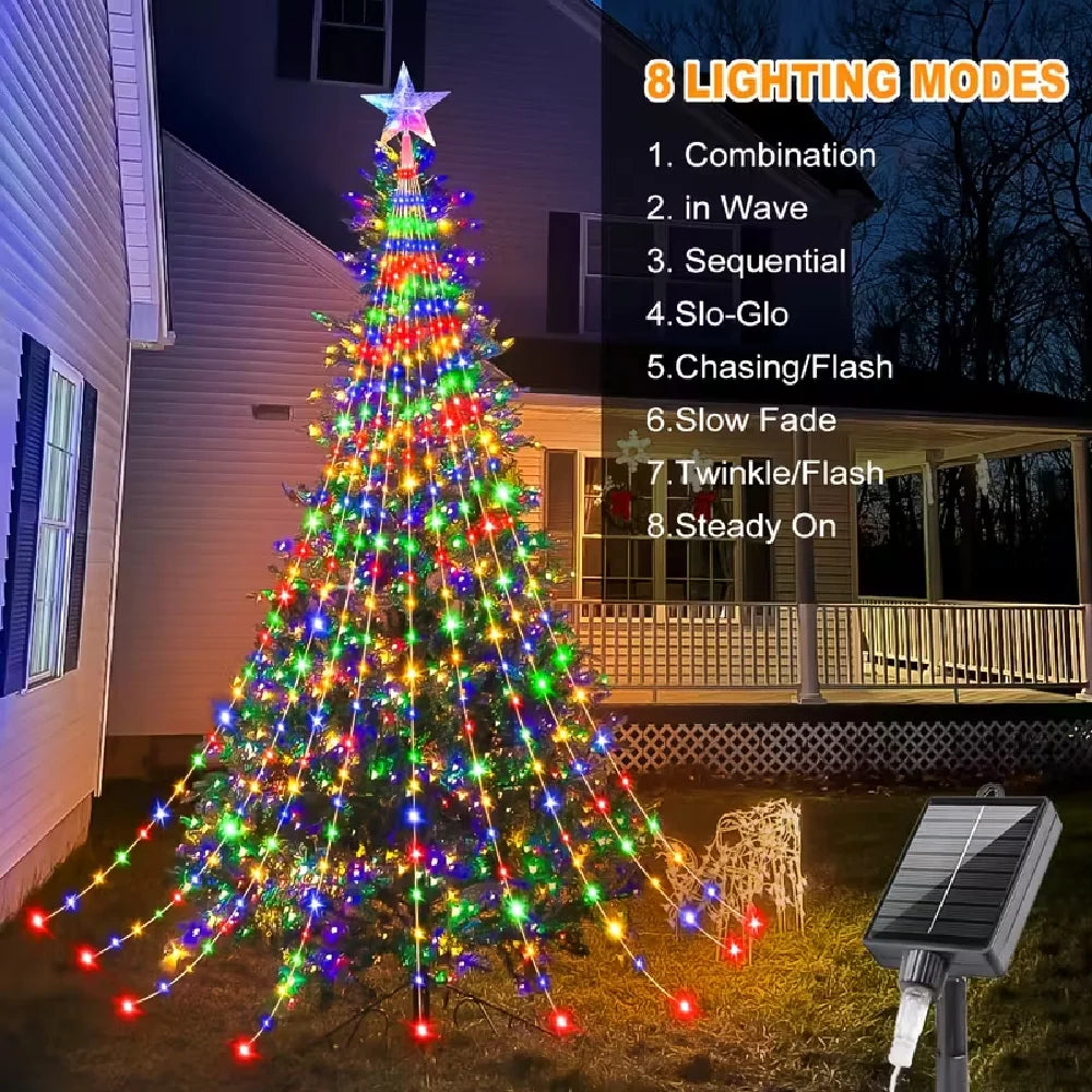 A decorated Christmas tree lights up in various modes outdoors with a solar panel nearby.