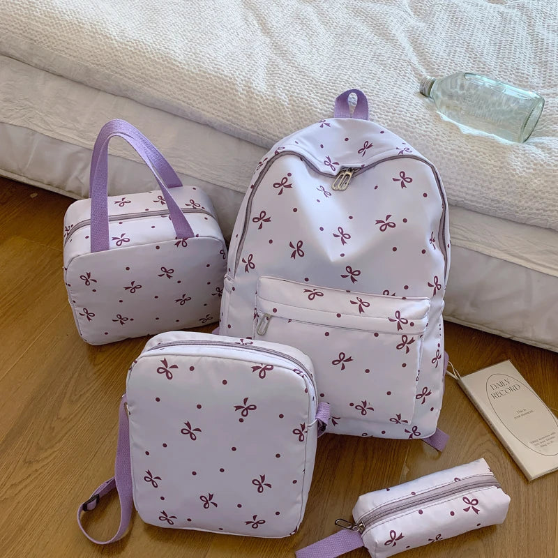 A set of women's backpacks and accessories featuring a white background with small purple bow prints.