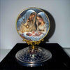 A golden-framed painting depicting the Holy Family with Mary, Joseph, and the infant Jesus.