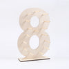 A light wood display stand shaped like the number 8, used for holding desserts or small items.