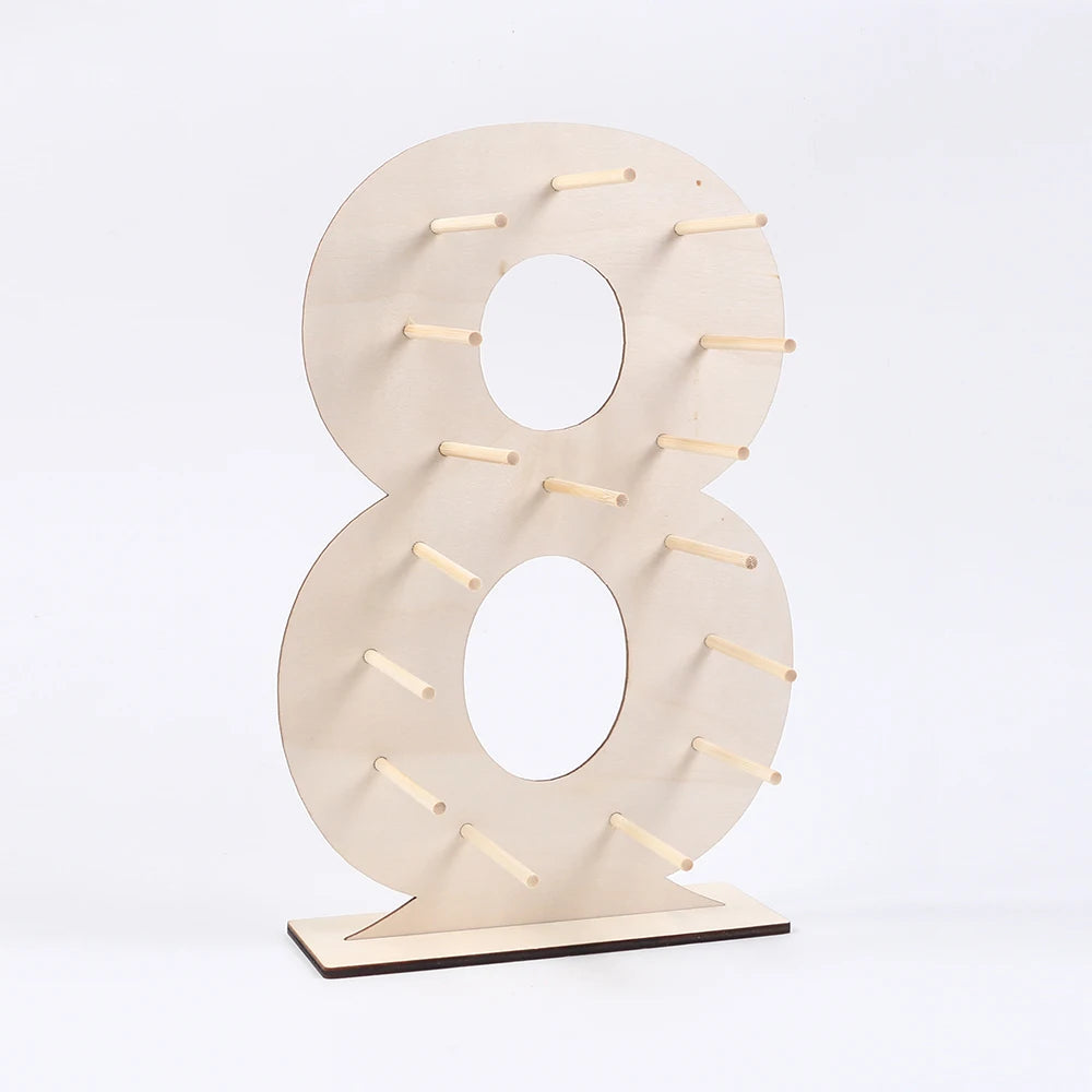 A light wood display stand shaped like the number 8, used for holding desserts or small items.