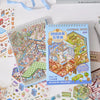 A colorful sticker book titled Material Book featuring a miniature 3D scene of a city.