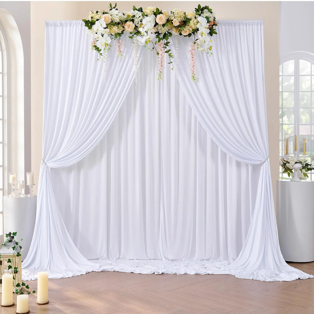 White pleated fabric backdrop curtain decorated with floral greenery for parties and photography