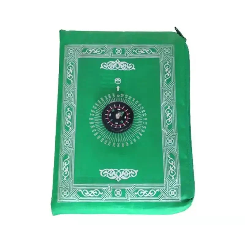 A green portable travel prayer mat with an ornate border and a compass design.
