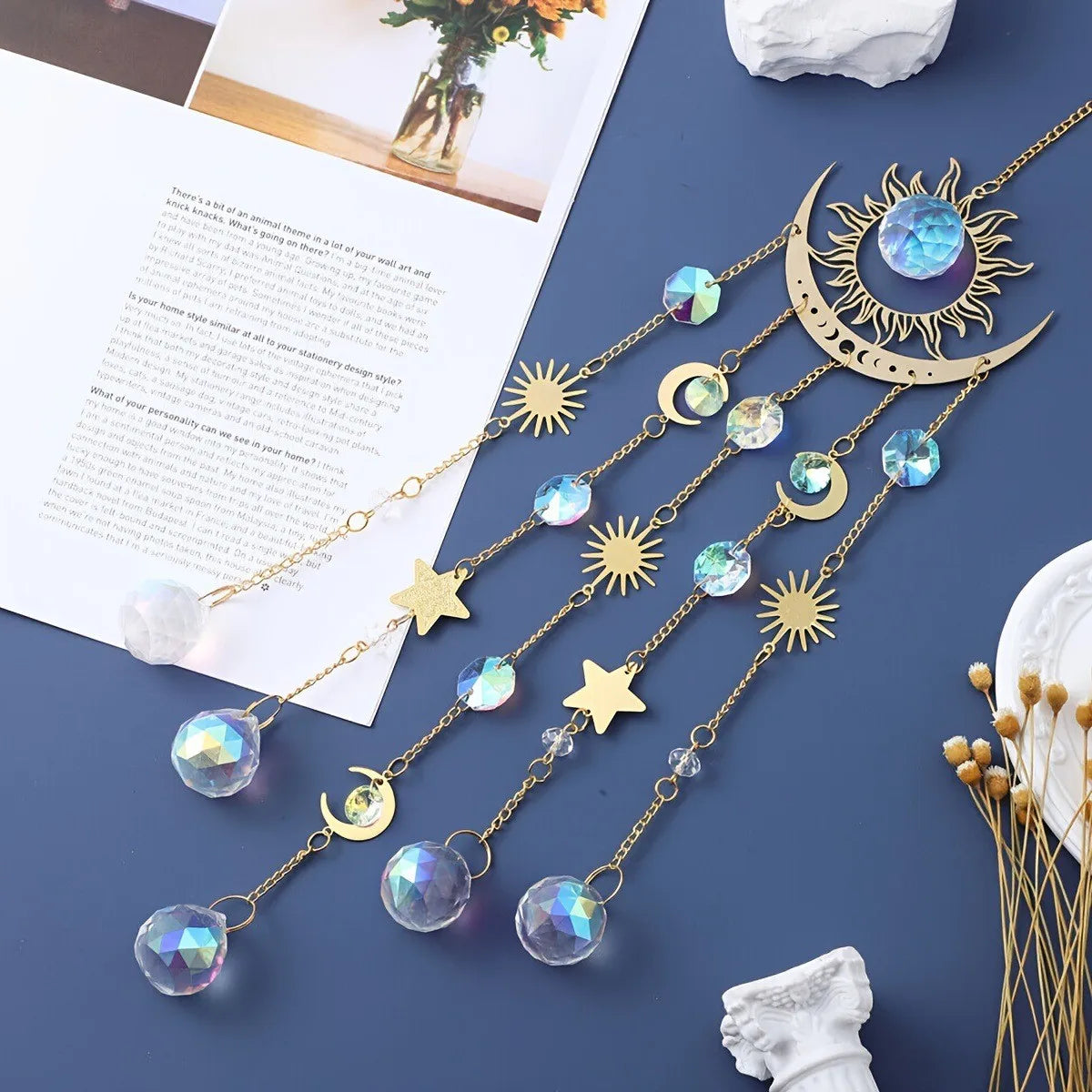 Gold flame moon crystal sun catcher jewelry featuring various celestial charms and crystals