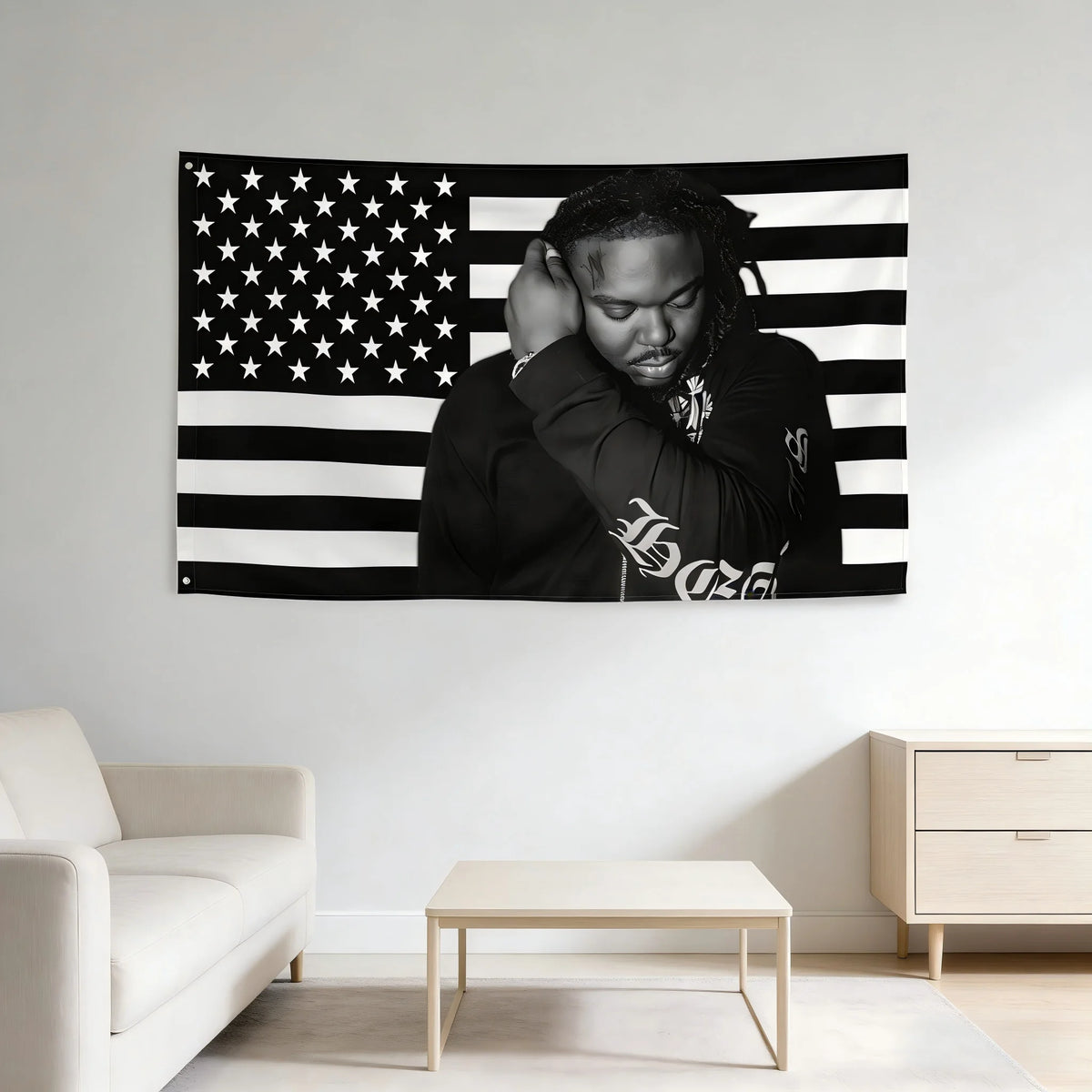 A black and white tapestry banner featuring the American flag design with a person's face superimposed.