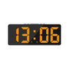 A black digital alarm clock displaying the time 13:06.