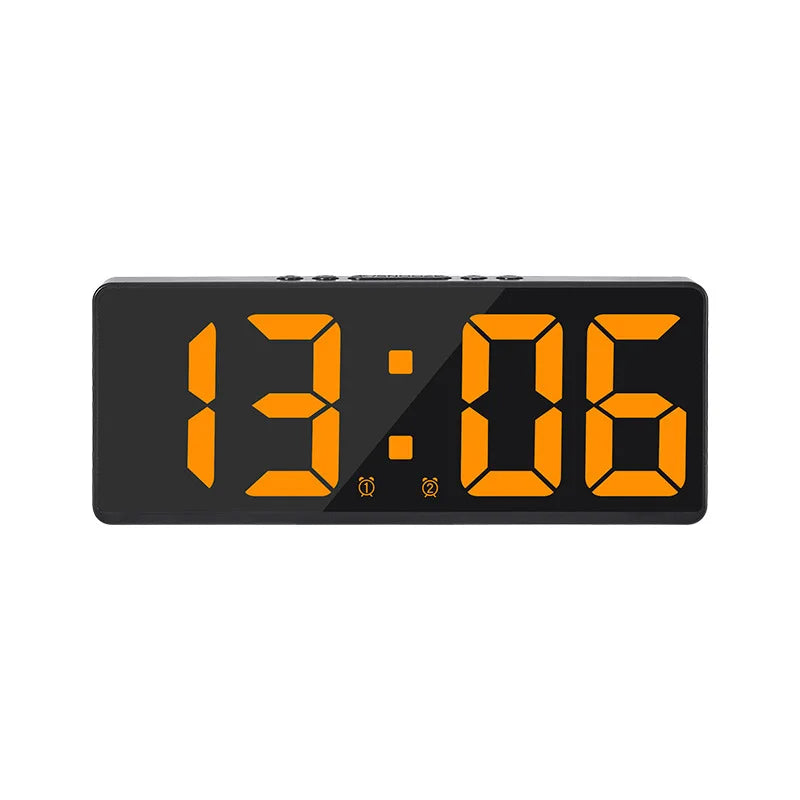A black digital alarm clock displaying the time 13:06.