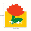 An orange flower design on a yellow card with the word Thanks written in green text.