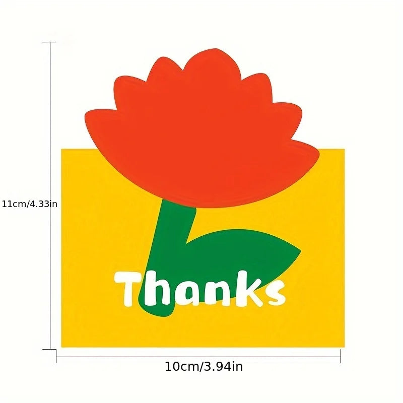 An orange flower design on a yellow card with the word Thanks written in green text.