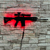 A red silhouette of an assault rifle is projected onto a gray stone wall.