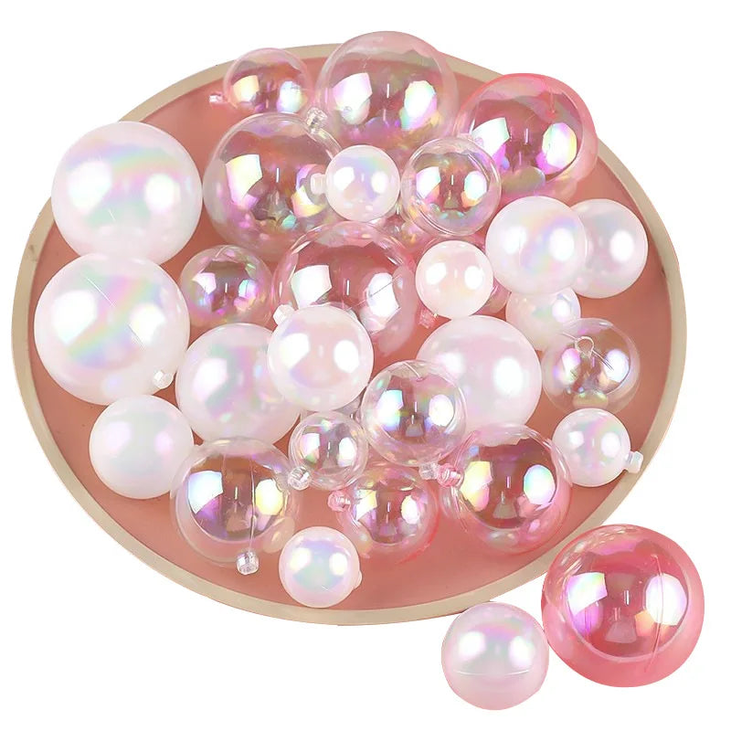 A collection of pink and iridescent pearl-like spherical balloon cake toppers arranged on a round plate.