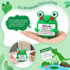 A hand holds a green crochet frog ornament with a tag that reads Never Frog-et the Difference You're Awesome