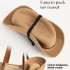 A tan straw wide brim sun hat is shown folded for travel, emphasizing its easy packing feature.