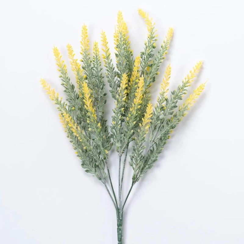 Sprigs of yellow lavender artificial flowers with green foliage
