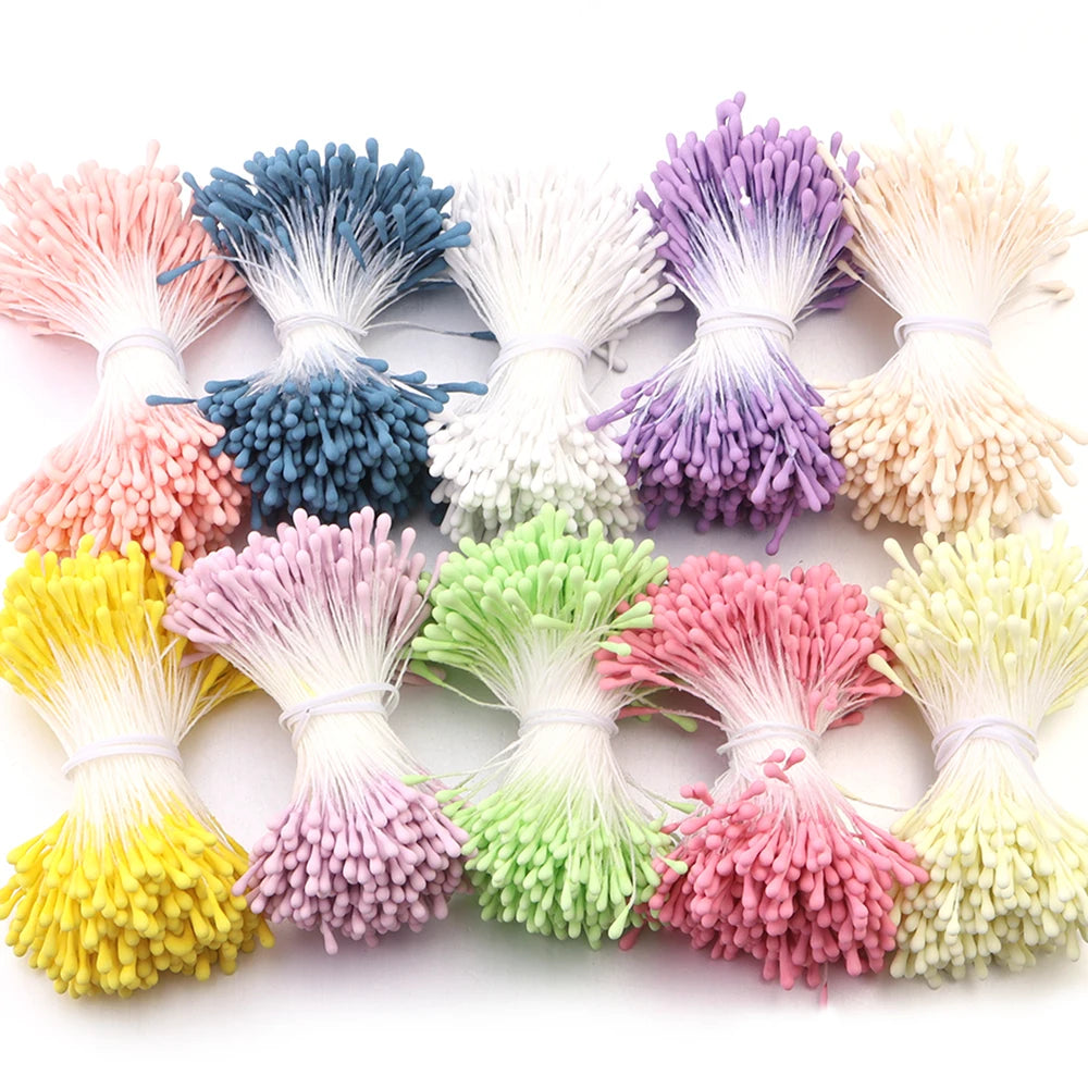 A collection of mini artificial flower stamens in various shades including pink, purple, yellow, and green.