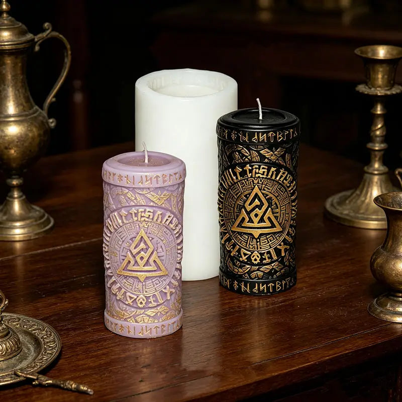 Three candles, one white and two dark, sit on a wooden surface next to a brass oil lamp.