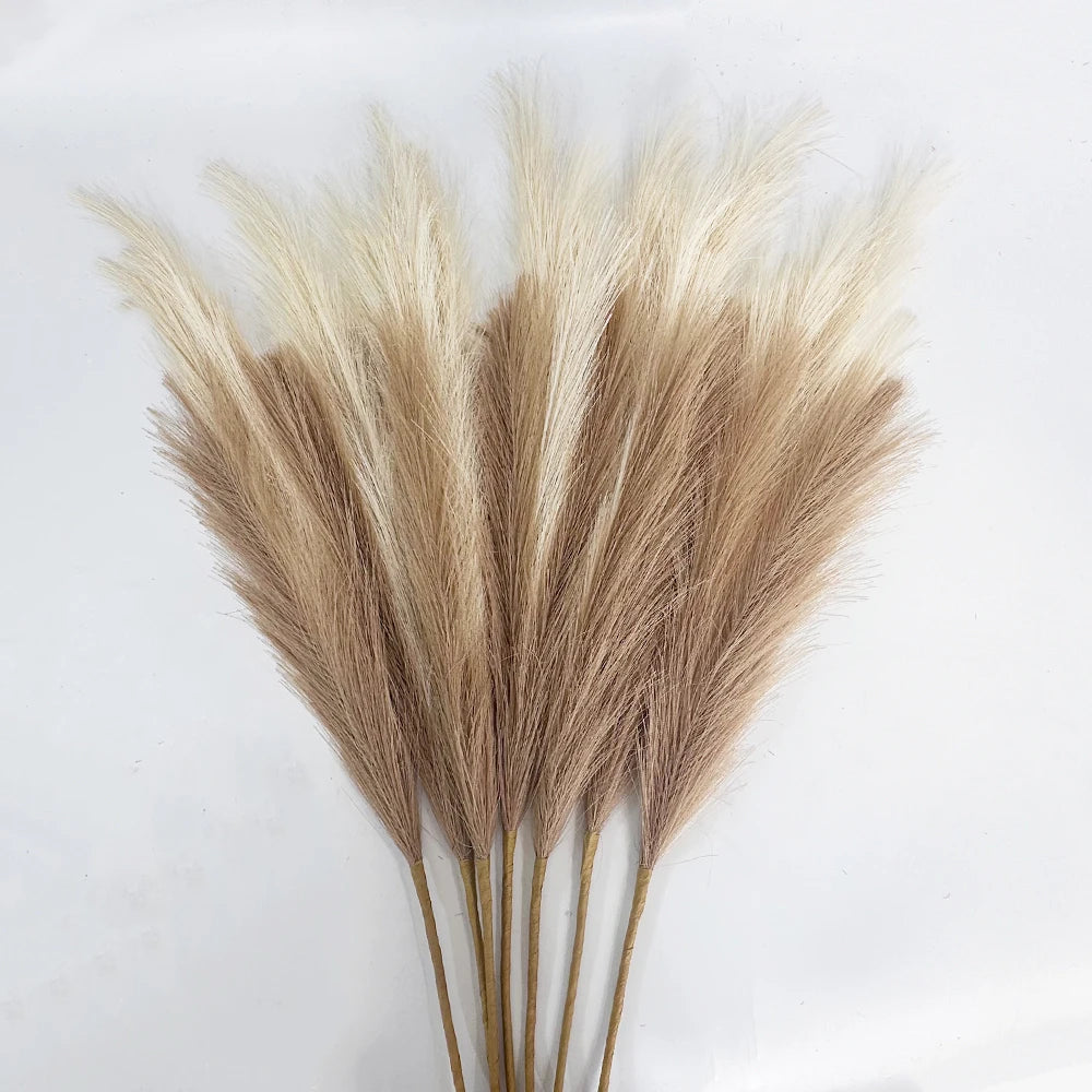 Dried artificial pampas grass branches in beige and tan tones used for boho home and wedding decor