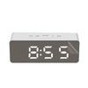 A rectangular digital alarm clock with a dark gray face displaying the time 8:55 and various function buttons.