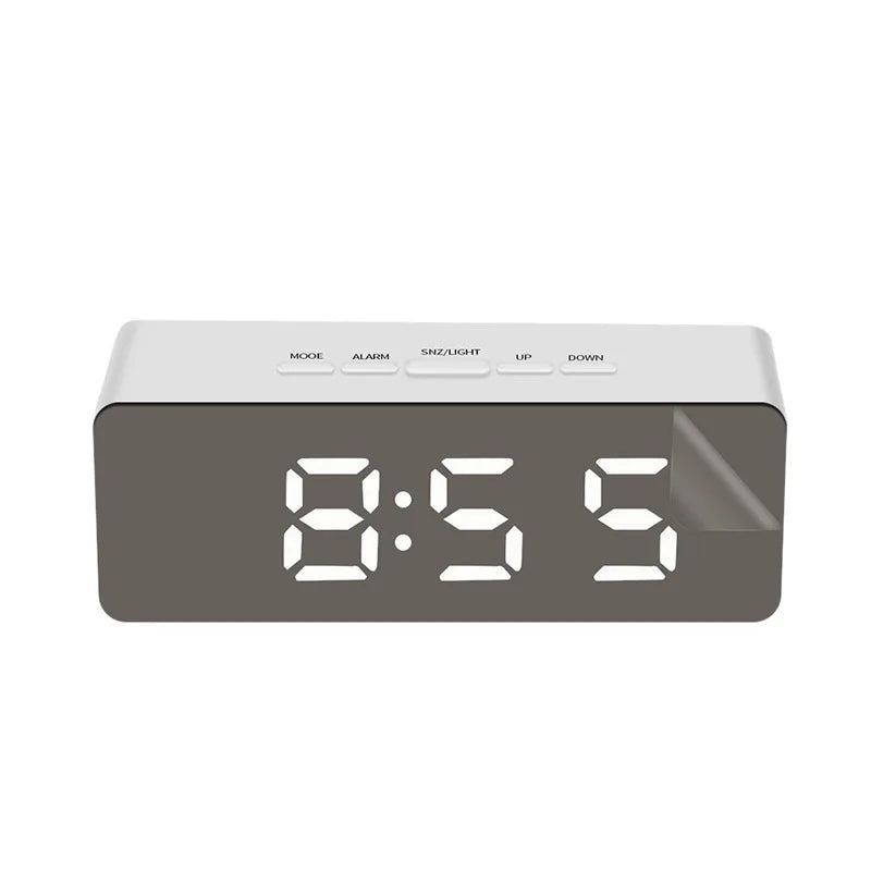 A rectangular digital alarm clock with a dark gray face displaying the time 8:55 and various function buttons.