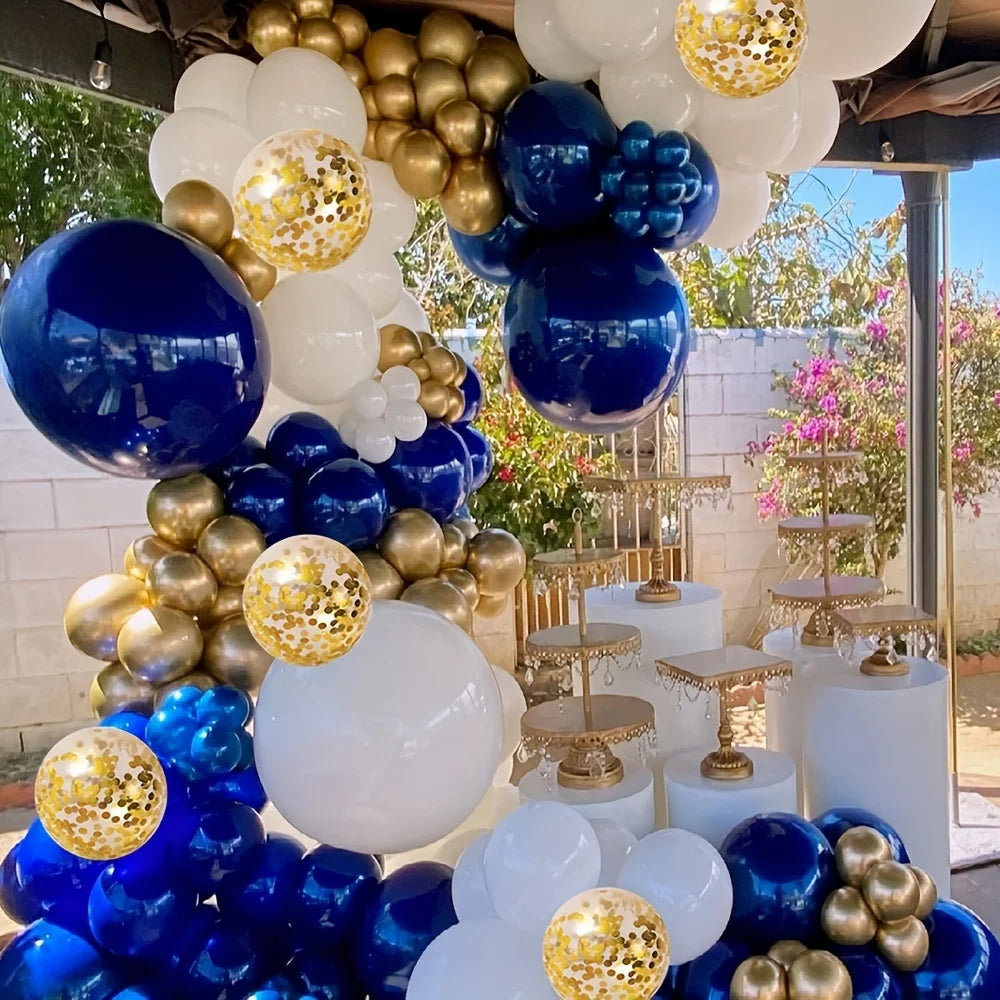 A balloon arch display featuring navy blue, gold, and white balloons for parties and celebrations.