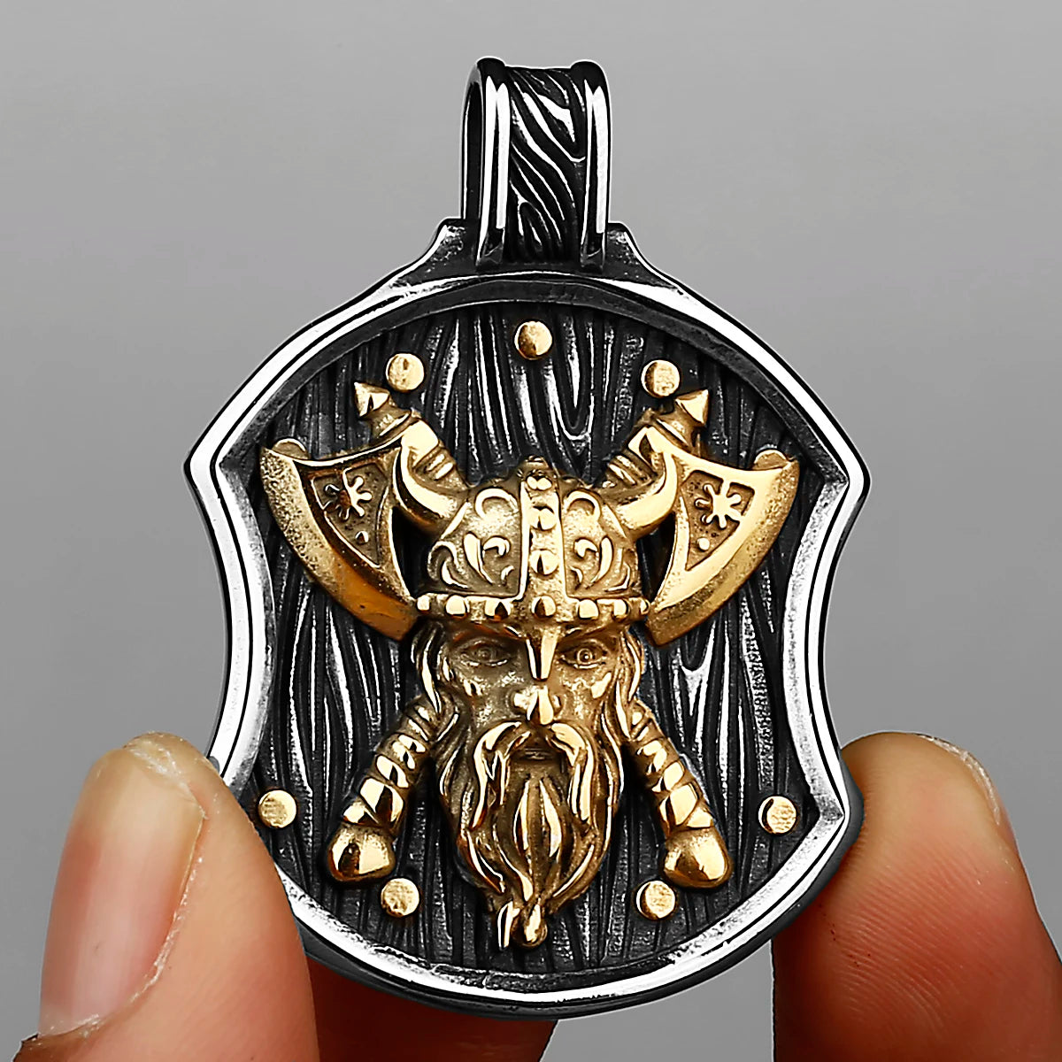 A stainless steel Viking warrior shield pendant featuring a detailed golden head and beard design.