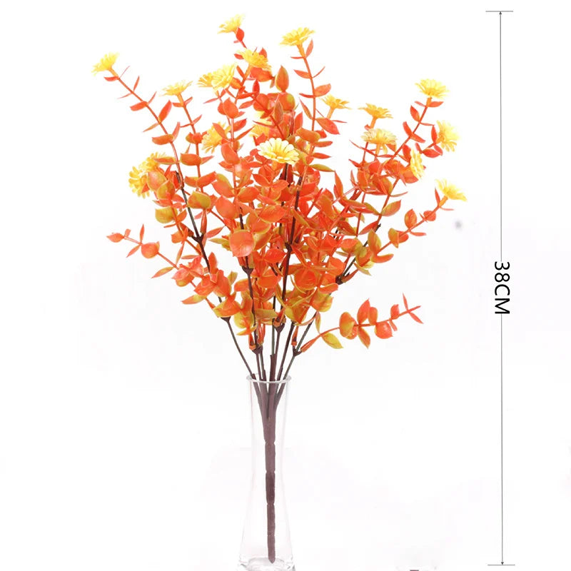 Artificial daisy bouquet with orange and yellow flowers on a thin stem displayed in a glass vase.