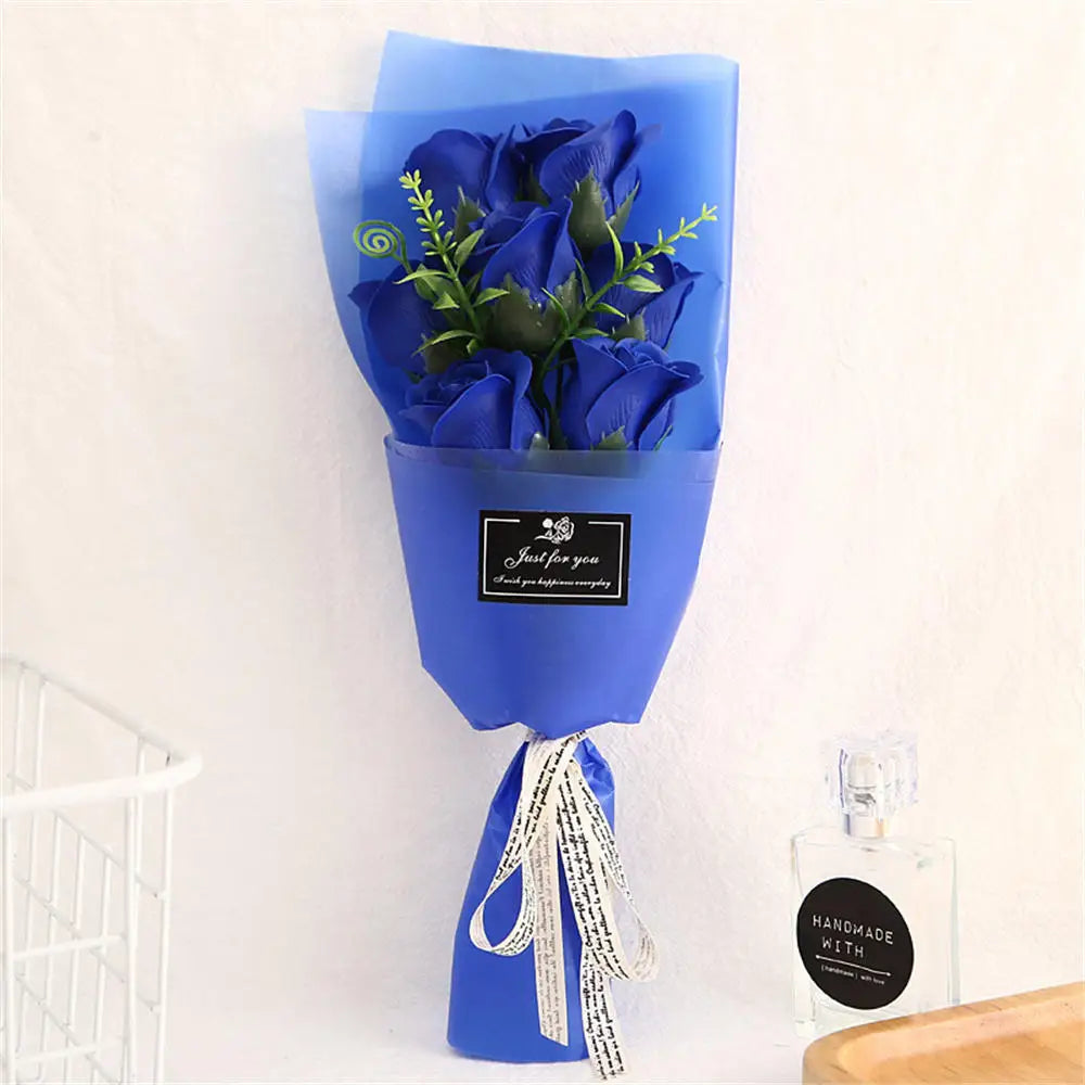 A bouquet of blue roses in a blue paper wrapping displayed against a white background.