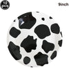A white plate with a black cow print design, packaged with ten pieces.