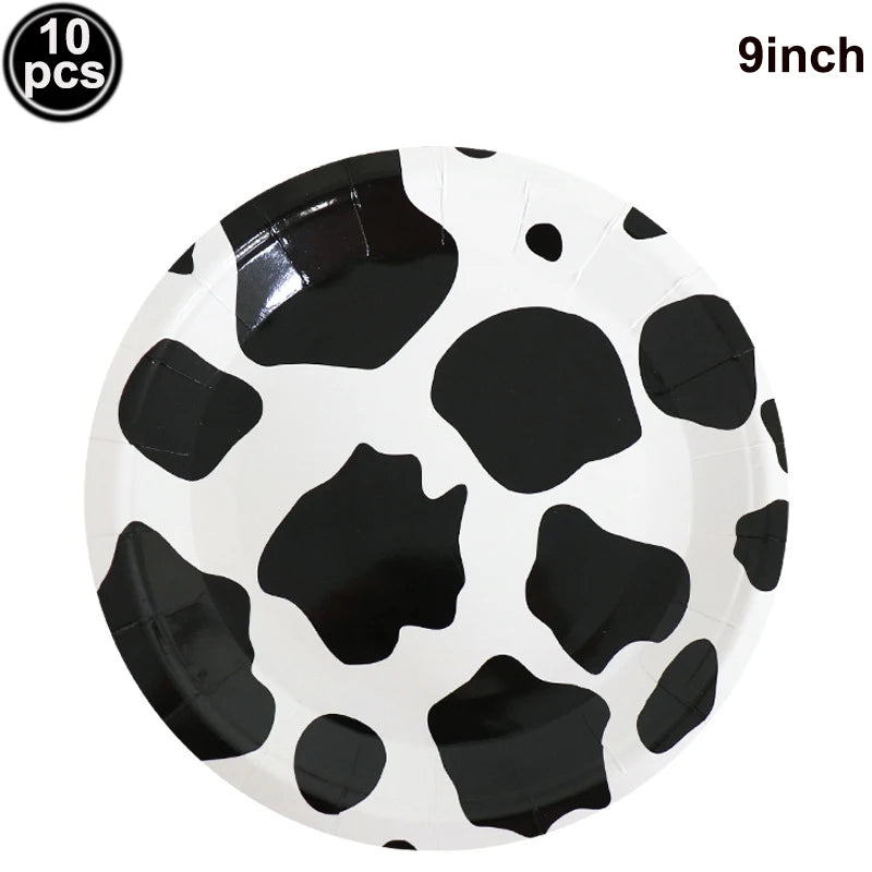 A white plate with a black cow print design, packaged with ten pieces.