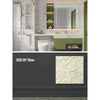 A modern bathroom vanity featuring marble wall decals, a sink, and green cabinetry.