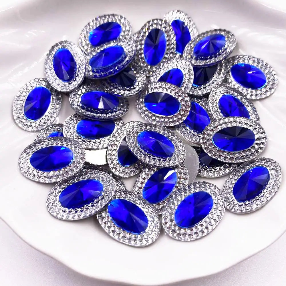 A pile of round, brilliant blue gemstone flatback rhinestones set in silver-toned metal.