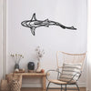 A black line sculpture of a shark swimming across a white wall above a wooden table and wicker chair.