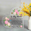 A clear heart-shaped acrylic keepsake plaque engraved with a floral design and the message I love you to my mum