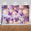 A dreamy purple butterfly photo backdrop featuring white floral arrangements and glowing lanterns.