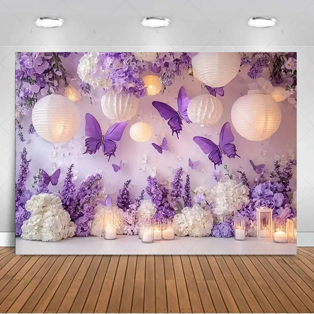 A dreamy purple butterfly photo backdrop featuring white floral arrangements and glowing lanterns.