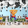 A decorative display featuring a golden soccer trophy, various black and white balloons, and soccer balls arranged for party 