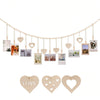 A string of heart-shaped beads and clips forming a decorative photo display garland.