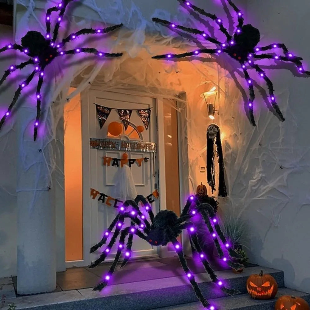 A display of LED light-up furry Halloween spider decorations with purple glow on a porch entrance.