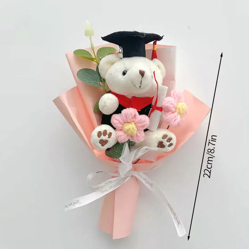 Handcrafted crochet flower bouquet featuring a teddy bear in a graduation cap and pink paper wrapping.