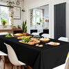 Elegant black disposable plastic tablecloth set for weddings and parties displayed on a table.