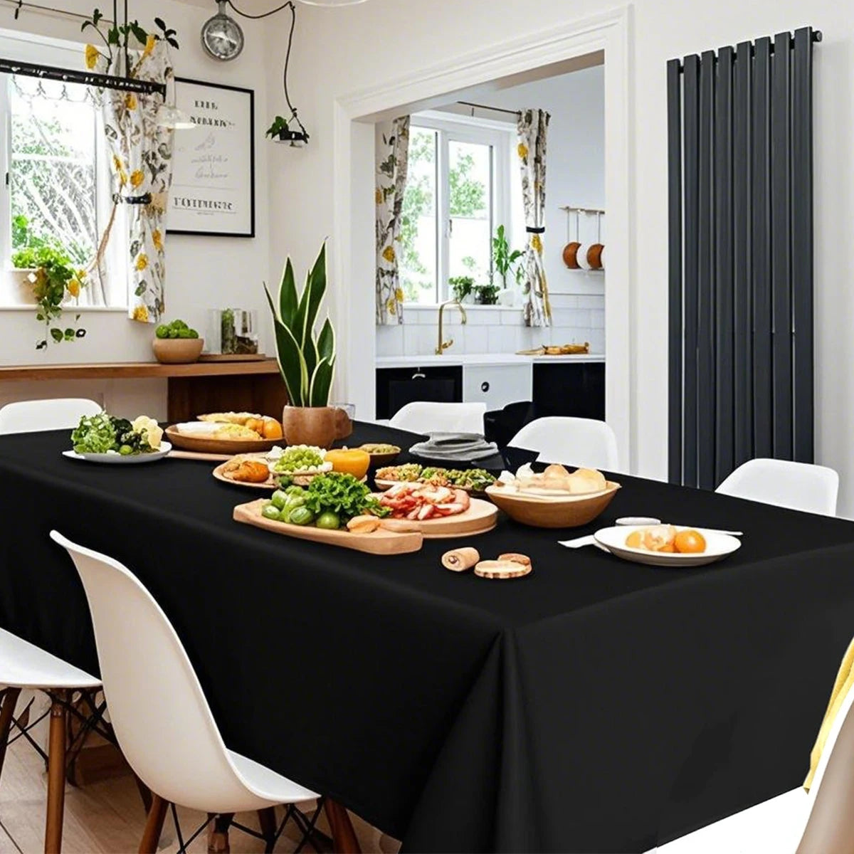 Elegant black disposable plastic tablecloth set for weddings and parties displayed on a table.