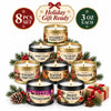 A set of eight holiday scented candles in gold tins with gift boxes and a card