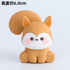 A cute, round, orange-brown animal figurine with large ears and white facial features.