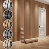 Vertical strips of faux wood grain self-adhesive wallpaper displayed on a wall with a white door.