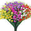 A vibrant bouquet of artificial flowers in various shades of purple, pink, yellow, and red.