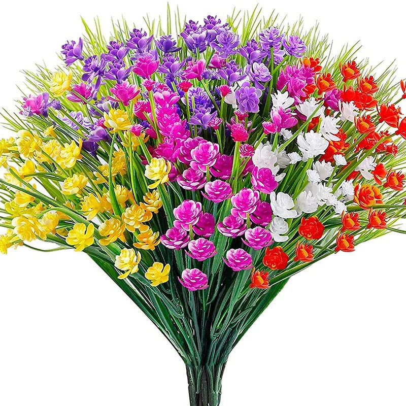 A vibrant bouquet of artificial flowers in various shades of purple, pink, yellow, and red.