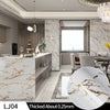 A close-up view of a white marble contact paper sheet with gold veining, used for DIY decor.