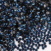 A close-up view of dark blue and black flatback resin rhinestones scattered on a white background.