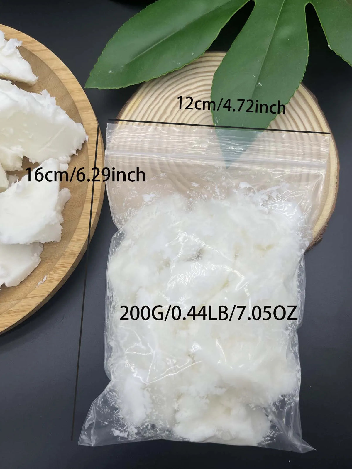 A clear plastic bag contains white natural coconut wax pieces next to a wooden board and green leaves.